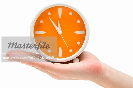 Woman holding an orange alarm clock. Isolated on a white background.
