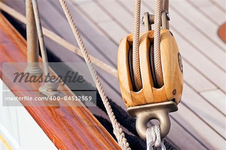 Detail of a wooden sailboat: pulley with ropes
