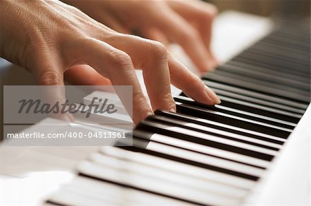 Woman's Fingers on Digital Piano Keys