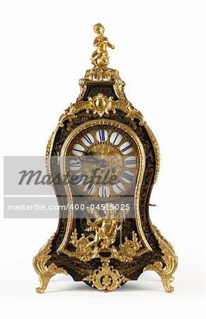 An antique clock ornate with golden Cupids and floral motives.