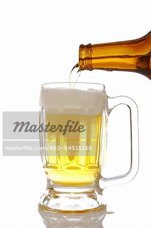 Pouring beer into mug reflected over white background