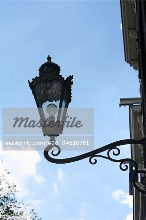 Old style street lamp mounted on a  wall