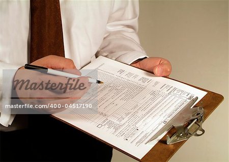 business man fills out a tax form