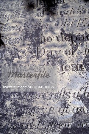 A section of an old distressed and eroded gravestone from the 1600's.  Background image for Halloween or anything spooky.  Scanned film.