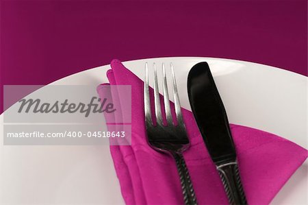 An elegant dinner table set in pink