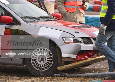 Detail of an car accident during a car race.