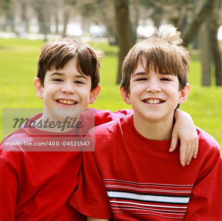 Two Brothers Smiling Both in Red