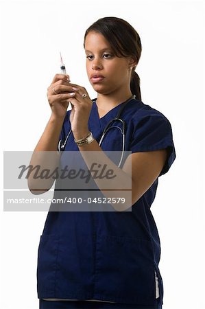 Young attractive African American  woman healthcare worker wearing dark blue scrubs and a stethoscope holding and looking at a syringe