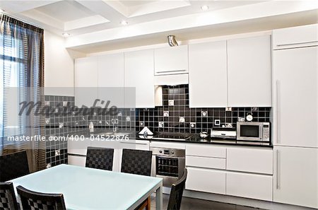 Interior of the modern kitchen with a table and chairs