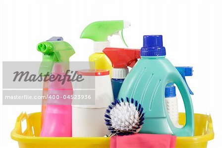 Cleaning supply bottles in a basket, isolated on white background