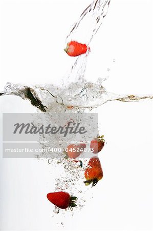 Strawberries in water floating and bubbling