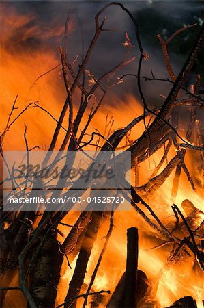 Burning wood in big bonfire place