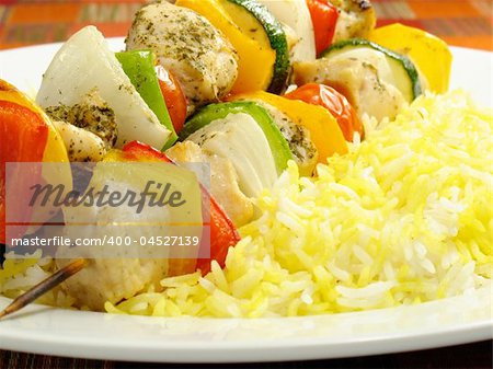 Seasoned chicken kebabs with bell peppers, onions, zucchini, and cherry tomatoes. Accompanied by a bed of saffron flavored basmati rice.