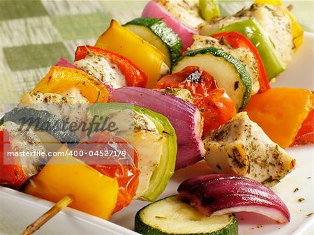 Seasoned chicken kebabs with bell peppers, onions, zucchini, and cherry tomatoes