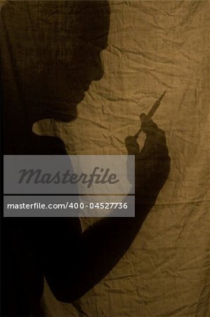 Shadow with the syringe over fabric