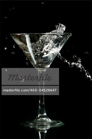 martini splash on black background close up