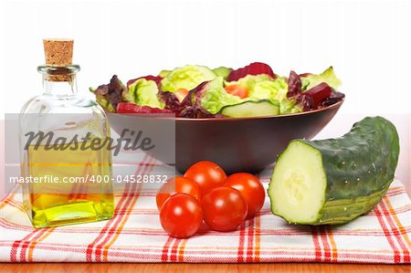 Mediterranean salad with lettuce tomatoes cucumber oil and beet. Shallow depth of field