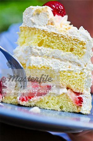 Slice of strawberry meringue cake on a plate