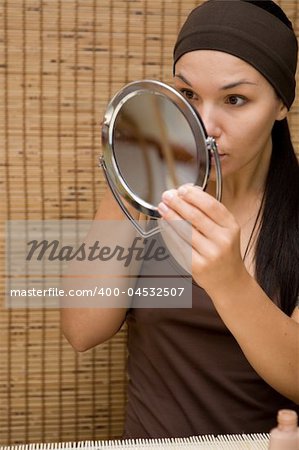 attractive brunette woman doing make-up