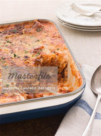 Lasagne in an Oven Dish with serving spoon