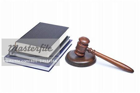 Wooden gavel from the court and law books reflected on white background. Shallow depth of field