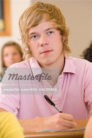 Male college student listening to a university lecture