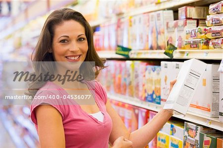 Woman grocery shopping in supermarket