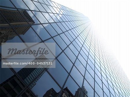 High modern skyscrapers on a background of a bright sky and clouds.