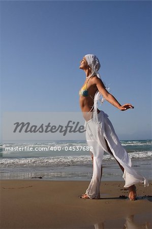 woman standing on shoreline at the beach in Greece