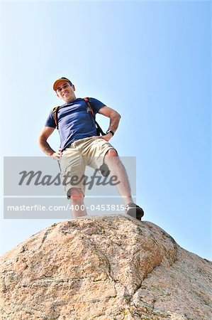 Middle aged hiker standing on top of a mountain