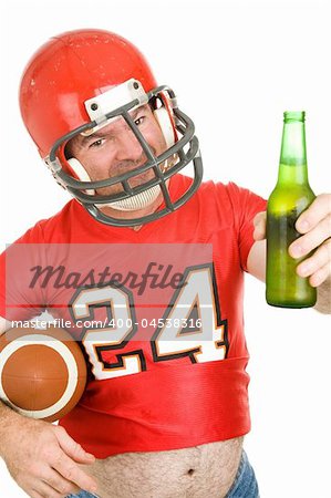 Middle aged football fan wearing his old uniform and having a beer.  White background.