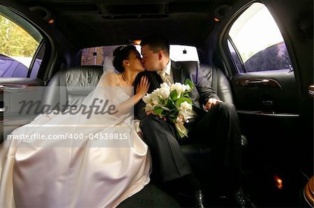 Kiss of a newly-married couple in car