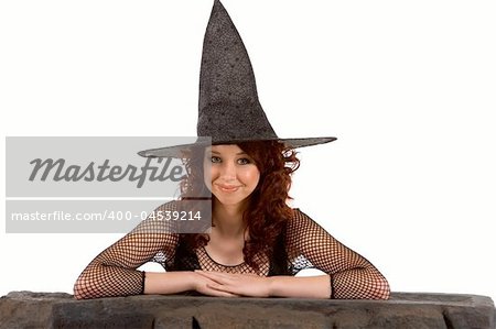 Portrait of Latina teenager girl in black Halloween hat and fishnet dress