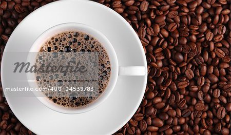 Cup of coffee. A background with coffee grains and a white cup. A photo close up
