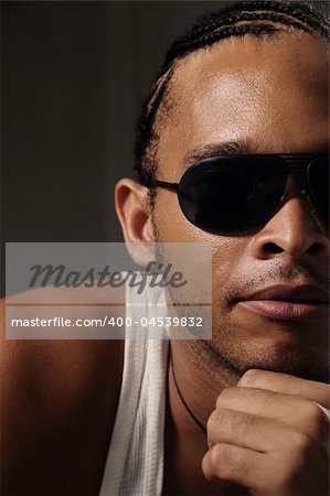 Portrait of young trendy african man wearing sunglasses