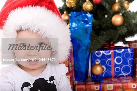 cute baby girl over christmas tree