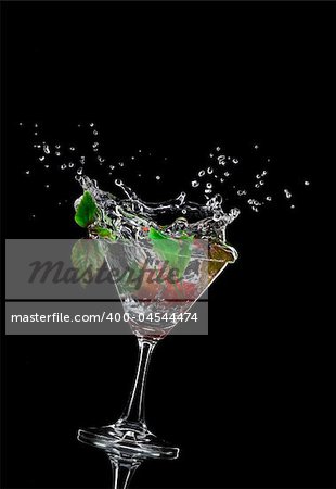 view of  martini glass with berry on black background