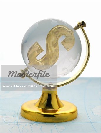 The globe and dollar. The glass globe on a yellow support, with a sign on dollar inside