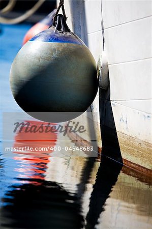 buoy tied to side of a fishing boat