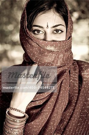 young mysterious indian woman in traditional sari