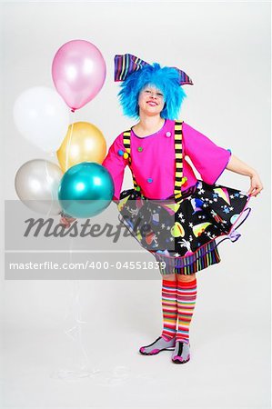 blue hair funny clown with color balloons in hand