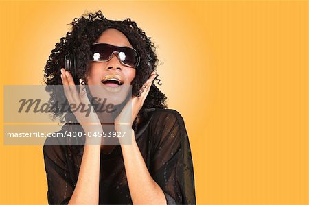 African Amercian Woman Singing While Listening to Music on Headphones