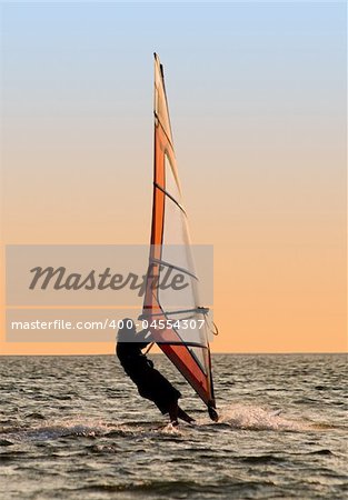 Silhouette of a windsurfer on a gulf