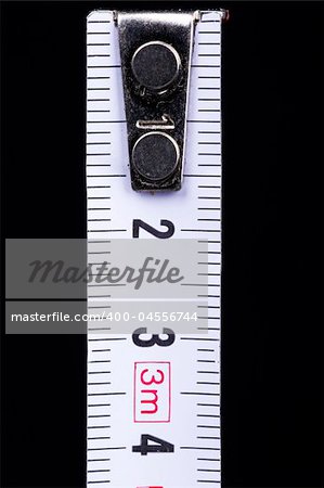 Measuring tape on black background