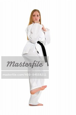 Black belt female martial artist doing low side kick