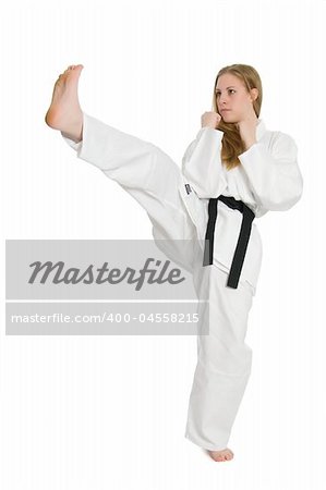 Black belt female martial artist doing front kick.