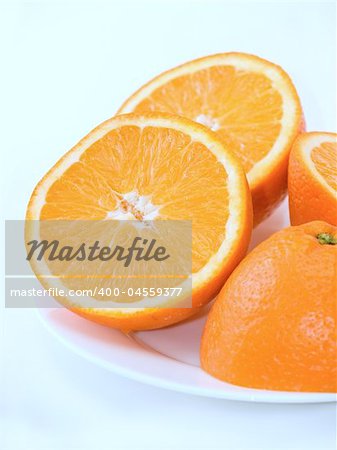Sweet fresh oranges on the plate over white background