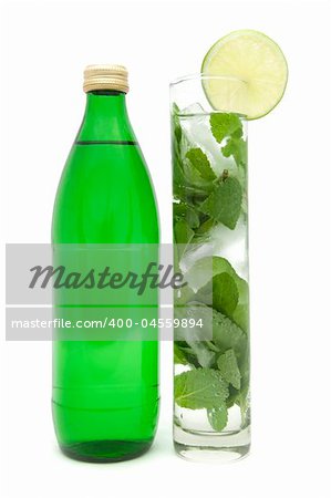 Mineral Water. Bottle and Glass with mint and ice rocks.