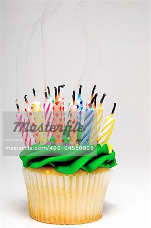 A cupcake covered in colorful birthday candles.