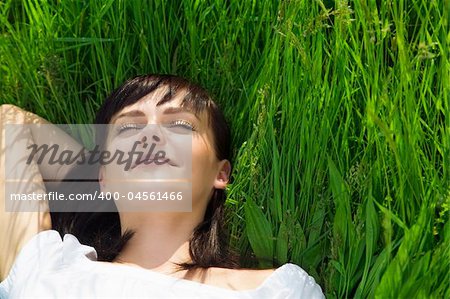 beautiful girl lying down of grass. Copy space